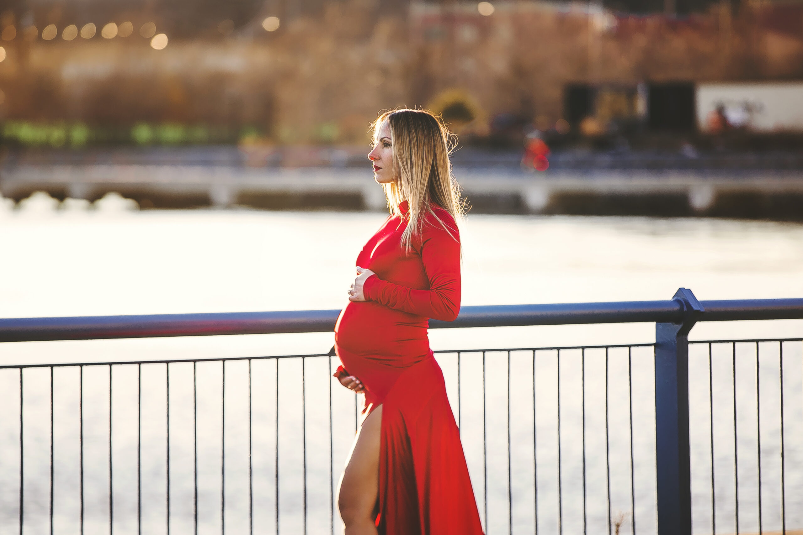 Vibrant Image at sunset of pregnant mom wearing red in the skyline by Austin photographer, Giselle Salazar