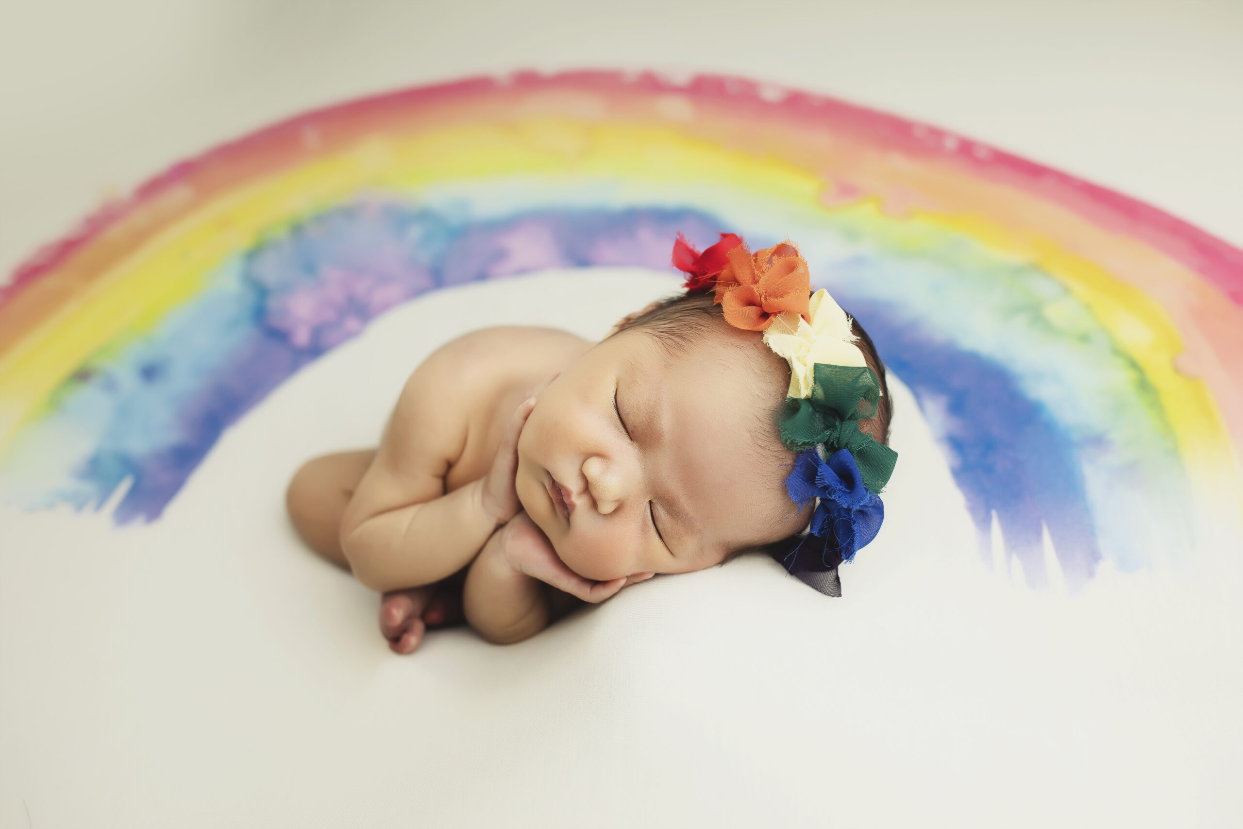 Rainbow baby themed newborn photo in Austin
