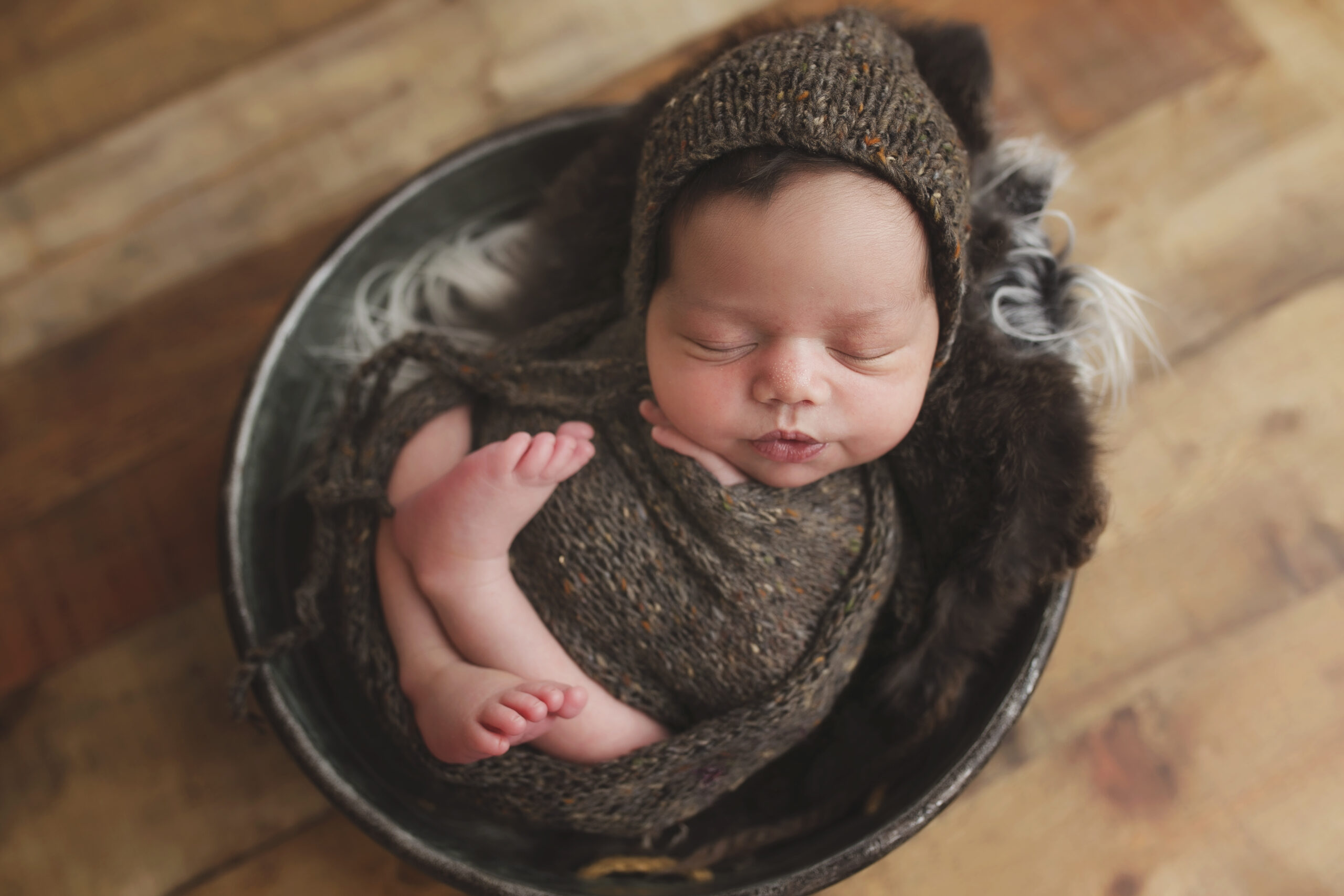 Wood and gray toned newborn photo by Austin photographer, Giselle Salazar